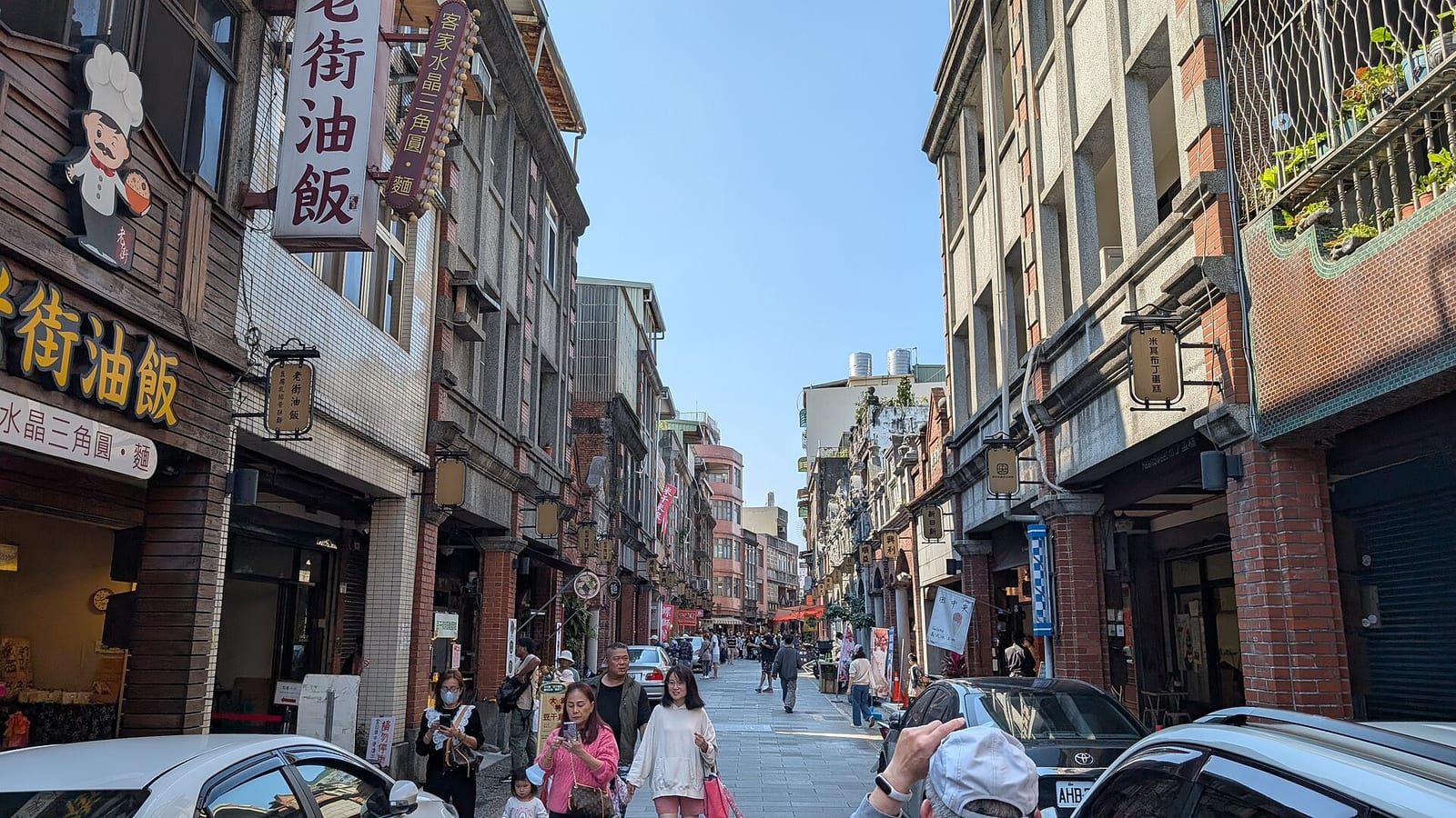 大溪老街街景，兩側為紅磚牌樓與商家招牌